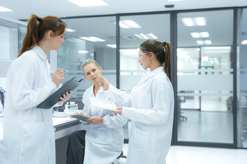 Researchers in a state of the art R and D institute discuss their findings. The facility's...