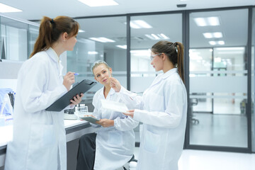 Researchers in a future open lab designed for cross disciplinary innovation share real time data on...