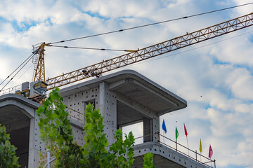 Against the backdrop of blue sky and white clouds, the working site of tower cranes at construction sites