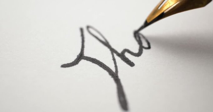 Signing a name on a contract with unique handwriting using an antique pen nib in black ink. Close up of a cursive signature on paper using a classic vintage fountain pens.