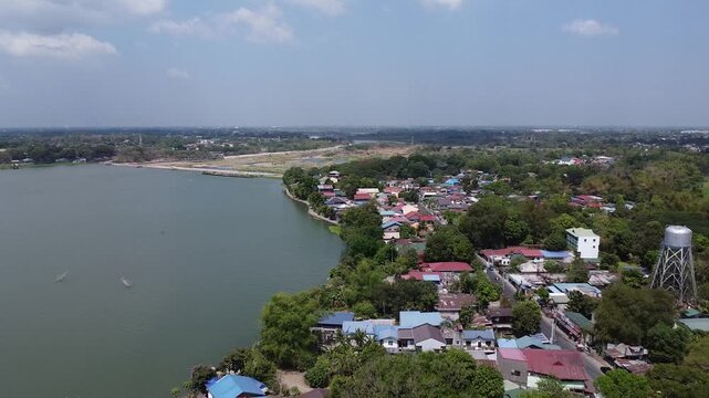 Aerial 4K Drone Shot of San Rafael Bulacan Showing Lakeside Community, Houses, Trees, and Water Tower &ndash; Peaceful Countryside and Rural Landscape in the Philippines