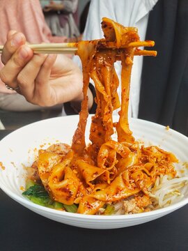 A typical Chinese culinary dish, biang-biang mian or popularly known as biang-biang noodles. The noodles are wide and served in a distinctive red sauce