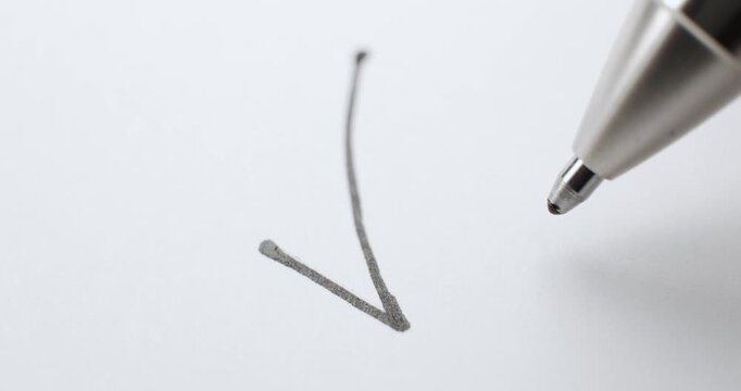 Pen with black ink drawing a check mark and a X on white paper. Checkmark and crossing out X showing approval or denial, a yes or no answer, or agreement or disagreement for a decision being made.