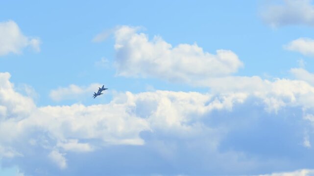 Slow motion view of two F 18 fighter jets flying at bright sky, showcasing military strength, speed, and precision.