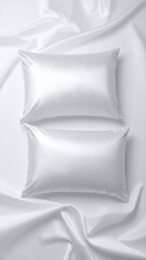 Two white silk pillows on a bed