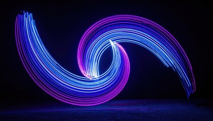 Intricate light trails form a swirling abstract composition against a dark backdrop, showcasing vibrant neon colors of blue and magenta with illuminated streaks, creating dynamic movement and a...