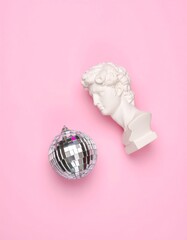 White bust and disco ball on pink