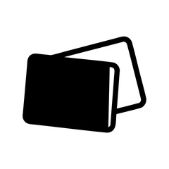 Two dark colored books with rounded corners stacked on top of each other