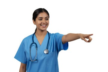 Confident female doctor pointing forward with a smile, offering guidance and expertise in healthcare settings.