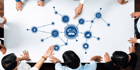 A top-down view of a collaborative business meeting where professionals discuss digital marketing...