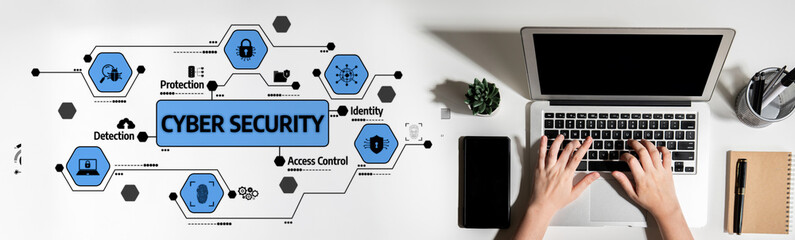 An overhead view of a laptop on a desk with graphic elements representing cyber security aspects...