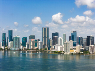 Naklejka premium Aerial view of Brickell skyscrapers. Modern cityscape of downtown Miami. Panoramic Miamis skyline above the coastline. Brickell Key aerial view in Miami. Landscape of Miami. Miami Beach and Brickell.