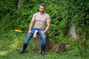 Lumberjack axe. Man with logging axe. Hardworking brutal man. Lumberjack hardworking outdoor. Brutal lumberjack. Brutality and masculinity. Hispanic lumberjack man with axe, advertisement