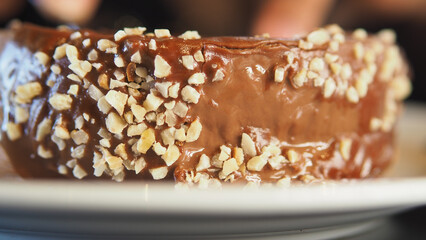 Chocolate dessert with nuts on a white plate