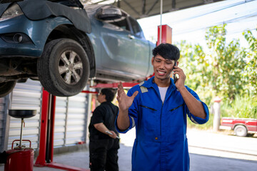 Mechanic talking on phone in auto repair garage