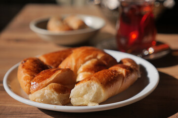 Freshly baked croissants served with tea in cozy cafe