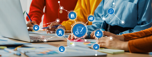 A vibrant workspace showcasing individuals collaborating on a laptop, surrounded by digital icons,...