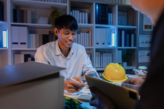 A diverse team of professionals shares ideas about architectural layouts and structural concepts, focusing on teamwork, creativity, and precision in modern engineering design discussions. - Powered by Adobe