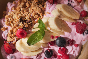 Fresh yogurt bowl topped with fruits and granola