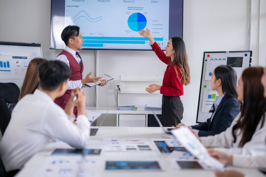 Asian business people giving presentation during corporate meeting