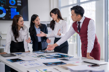 Business team analyzing data on desk in meeting room