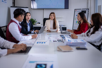 Asian business team meeting discussing company strategy and financial performance