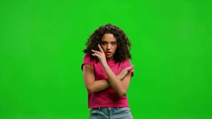 Young african american woman dancing and having fun on a green screen background in studio shot - Powered by Adobe