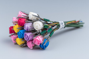 Colorful tech bouquet of roses made from electronic components and wires, a unique and quirky gift for the tech enthusiast or engineer, a creative concept for the modern maker