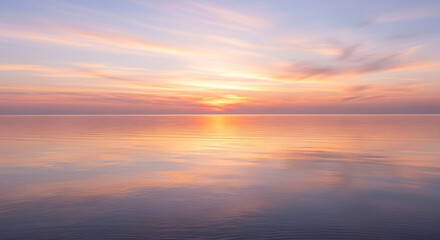Breathtaking pastel sunset reflecting on tranquil ocean water creates a peaceful, serene atmosphere perfect for meditation and mindfulness retreats