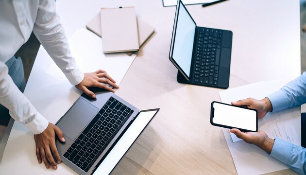 Teamwork with laptops and smartphone on a table.