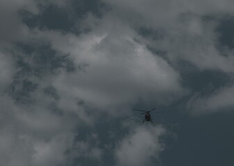 Helicopter flying through clouds at night