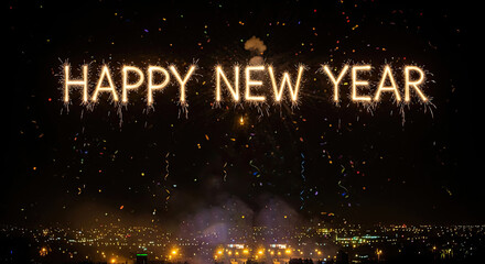 A city skyline at night with fireworks in the sky and confetti falling.