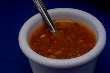 Hot chili sauce on yellow background