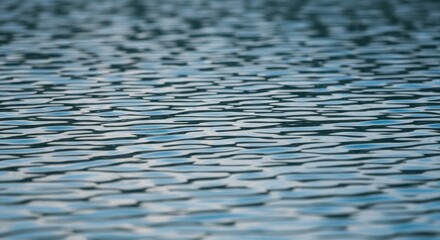 Tranquil water surface with gentle ripples and subtle color variations