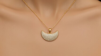 Close-up studio shot of a dainty gold crescent moon pendant necklace adorned with tiny sparkling stones, worn by a woman