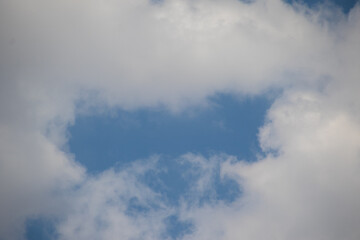 A gap in the clouds resembles the square opening of a letter box image for background use