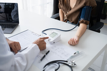 Doctor checking  patient arterial blood pressure. Health care measuring blood pressure of patient