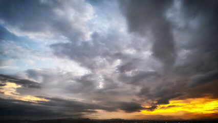 Dramatic clouds with golden sunset creating a striking sky scene