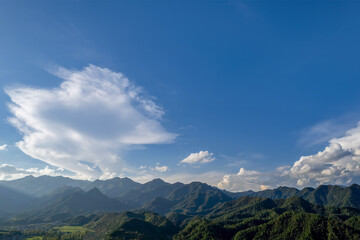 Beautiful Landscape with Blue Sky and White Clouds Over Mountain Ranges