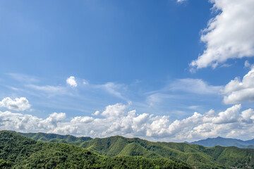 Fototapeta premium Beautiful Landscape with Green Mountains and Blue Sky