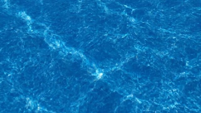 Deep blue ocean water with shimmering light reflections, a serene and vast aquatic expanse providing a sense of tranquility and depth for a peaceful natural background