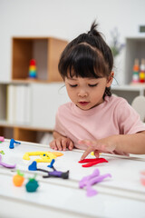 toddler girl with sculpting from plasticine