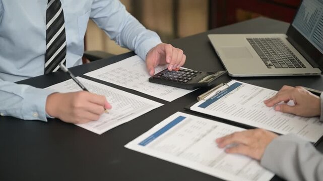 Finance and accountant team working in office for accounting and preparation services for financial statements and cash flow with analyze data insight for finance and taxation planning.