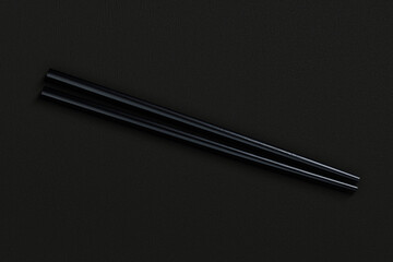 Pair of reusable chopsticks on dark background
