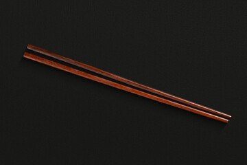 Pair of reusable chopsticks on dark background