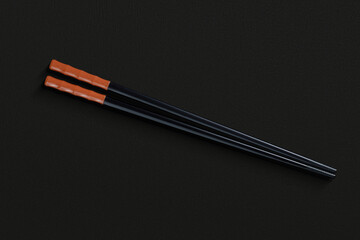 Pair of reusable chopsticks on dark background