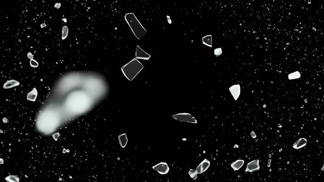 Sphere of shattered glass fragments exploding outwards on black background.