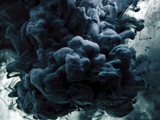 Abstract dark blue-green ink spreading in water, creating dynamic and intricate swirling patterns and textures.