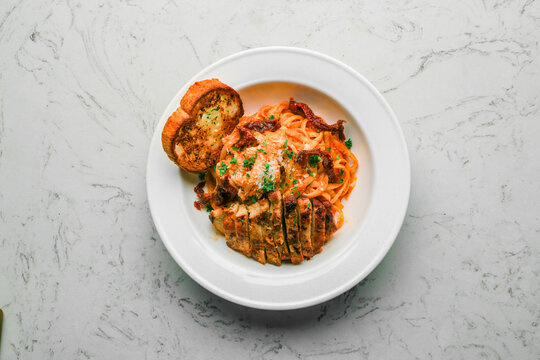 Chicken Pomodoro Linguine, Sun-dried Tomatoes, Creamy Tomato Base, and Parmesan