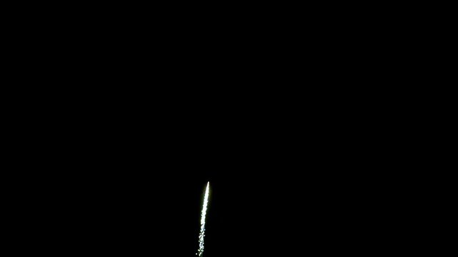Two fireworks exploding consecutively in the dark night sky depicting festive celebration 